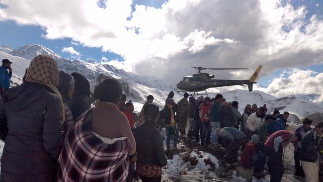 A Nepalese Army helicopter rescues survivors of a snowstorm in Manang District, along the Annapurna Circuit Trek. Picture: AP Photo/Nepalese Army