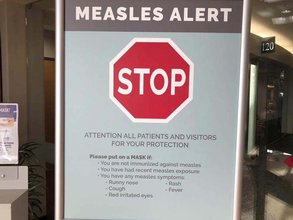 Signs posted at The Vancouver Clinic in Washington, warning patients of a measles outbreak.