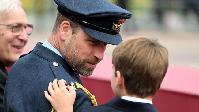 Prince William speaks with Louie. Photo by Eddie MULHOLLAND / POOL / AFP
