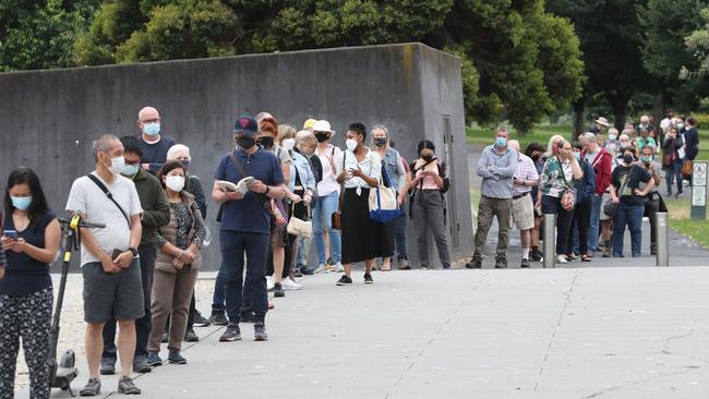 People queue at the Melbourne Royal Exhibition to get their booster jabs. Picture: David Crosling