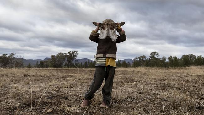 Harry Taylor, 6, wears what he calls his 'monster hat'. The bones of dead livestock have become a common sight on the Taylor family farm. Picture: Getty