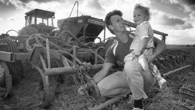 Alan Stringer with son Dylan on the farm in 1989.