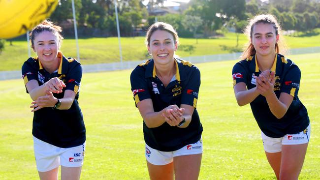 Brenna Tarrant, right, at 17 with East Coast Eagles players Bre Dannellan and Jordan Roughan.