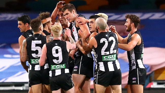 The Pies came from all parts of the ground to celebrate with Mason Cox. Picture: AFL Photos/Getty Images