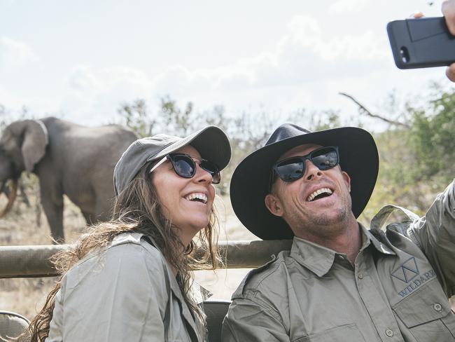 Mick Fanning and Tyler Wright get a selfie with a friend.