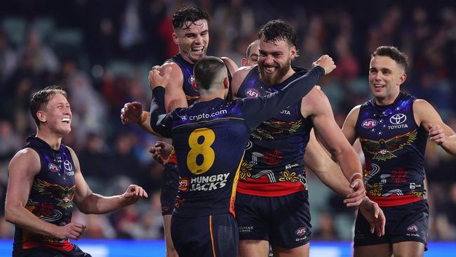 ADELAIDE, AUSTRALIA - JULY 13: Riley Thilthorpe of the Crows celebrates a goal with team mates during the 2024 AFL Round 18 match between the Adelaide Crows and the St Kilda Saints at Adelaide Oval on July 13, 2024 in Adelaide, Australia. (Photo by Sarah Reed/AFL Photos via Getty Images)