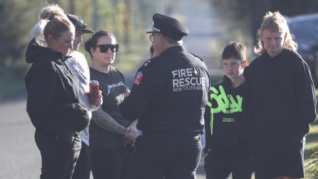 Families talk to fire and rescue personnel. Picture: John Grainger