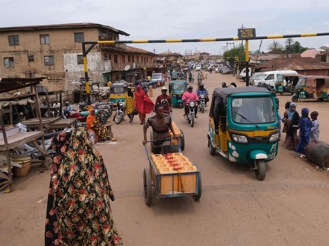 A general view of a street in the city of Jos, Plateau State, Nigeria, on May 15, 2021. - For years, the central Nigerian city of Jos was a flashpoint for ethnic strife pitting Christian and Muslim youth against each other in clashes in their rival neighbourhoods. Neighbour turned against neighbour as Muslims dared not cross into Christian neighbourhoods and Christians steered clear of Muslim dominated quarters. But community leaders have turned to football and music as a way to reach across the divide in a programme successfully building trust and restoring the peace. (Photo by Kola Sulaimon / AFP)