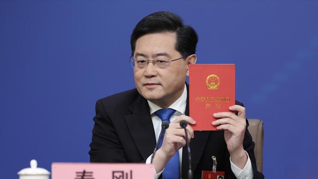 Qin Gang holds up China's constitution on March 7 in Beijing. Picture: Getty Images