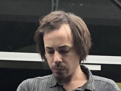 Mark Edward Attalla is led out of Manly Court House by police after  being convicted of pointing a handgun at a family in a car and a man he had an argument with on the bus. He was sentenced to 15 months in jail.  Picture: Jim O'Rourke