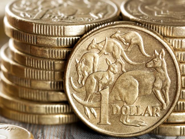 Stacks of Australian one dollar coins. Focus on front coin.