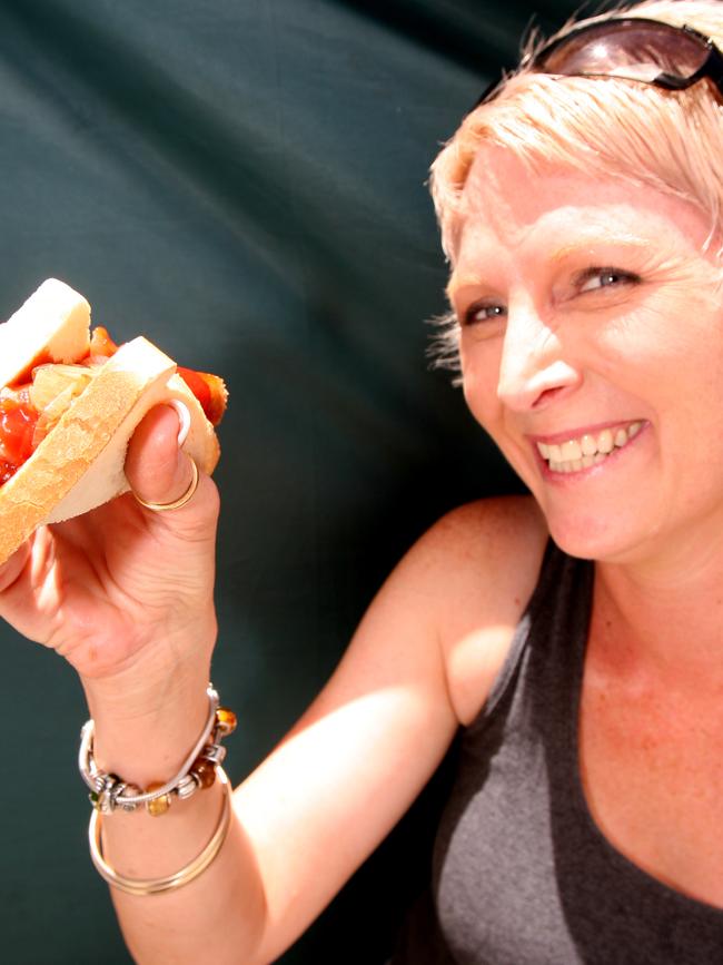 Part of Australian culture: a woman abouts to devour a Bunnings sandwich.