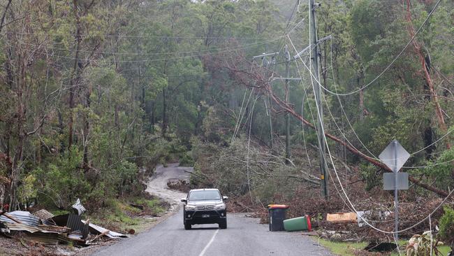 Kriedeman Rd at Guanaba was unrecognizable after storms then floods tore through the area. Downed powerlines and debris litter the area.. Picture Glenn Hampson