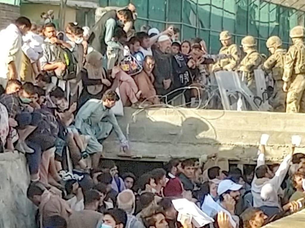 Security personnel assist with evacuation of the people waiting outside the airport in Kabul, Afghanistan. Picture: Twitter/David Martinon via Reuters