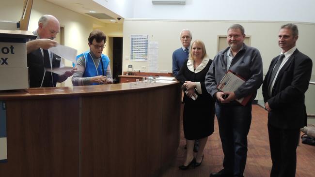 The Hills Returning Officer Wayne Donaldson and senior officer Carol Cope carry out the draw to decide which order the Mayoral candidates will be on the ballot. Hills Shire Mayoral candidates: (L to right) Ray Brown (Building Australia Party) Michelle Byrne (Liberal), Tony Hay (Labor) Jeff Lowe (independent