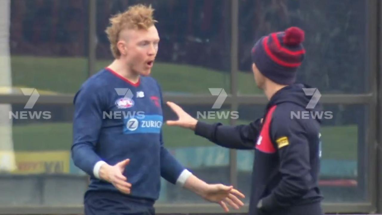 Clayton Oliver is seen arguing with a trainer at training.
