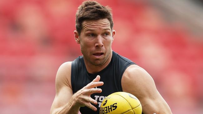 SYDNEY, AUSTRALIA - SEPTEMBER 12:  Toby Greene of the Giants handles the ball during a Greater Western Sydney Giants AFL training session at ENGIE Stadium on September 12, 2024 in Sydney, Australia. (Photo by Matt King/Getty Images)