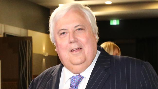 Palmer United Party (PUP) leader Clive Palmer, accompanied by PUP Senators Glenn Lazarus and Dio Wang, arrives to address the National Press Club in Canberra today.