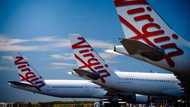 Virgin Australia aircraft are seen parked on the tarmac at Brisbane International airport. Picture: Patrick Hamilton / AFP)