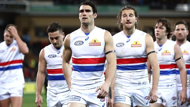 Disappointed Bulldogs players leave Adelaide Oval after the loss. Picture: Getty