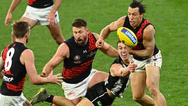 Dylan Shiel shoots out a handpass under pressure from Callum Brown on Friday night.