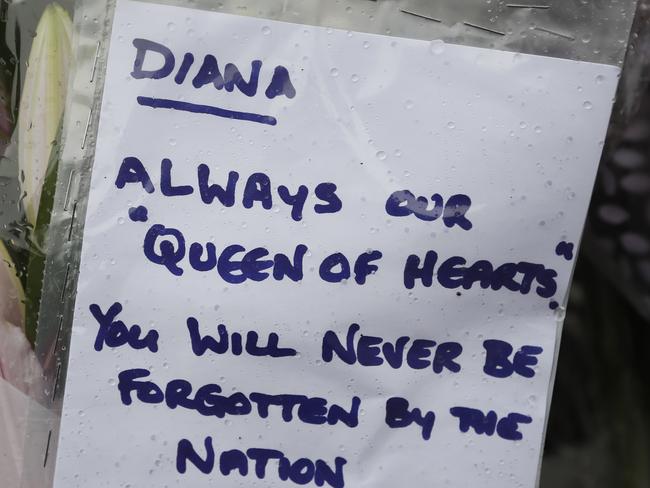 A tribute to the late Princess Diana is attatched on the gates outside of Kensington Palace, in London. Picture: AP