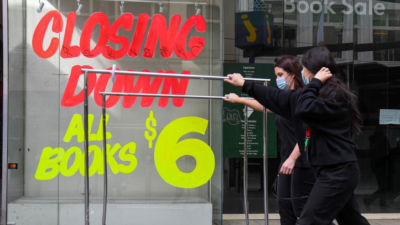 Workers push trolleys past an empty shop in Melbourne’s CBD in early August. Picture: William West/AFP