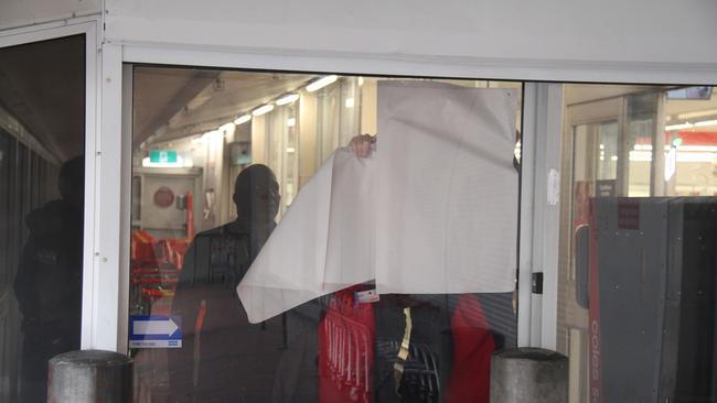 A Coles employee blocks the window at the Alice Spring Coles. Picture: Gera Kazakov