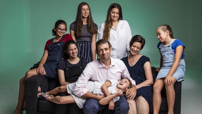 Dr Justin Coulson with wife Kylie and daughters Emilie, 5, Annie, 12, and Ella 16 (striped skirt) and Abbie, 17, Chanel, 20 (white shirt), amd Lilli, 9. Picture: Mark Cranitch.