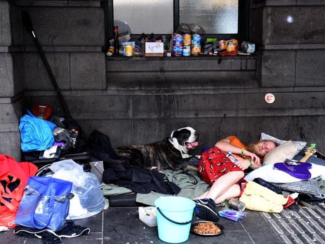 A homeless man and his dog outside Flinders Street Station. The person photographed is considered genuinely homeless. Picture: Nicole Garmston
