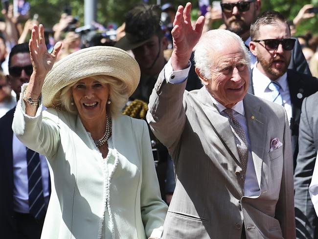 King Charles and Queen Camilla wave as they walk during a visit to a church in Sydney. Picture: Toby Melville-Pool