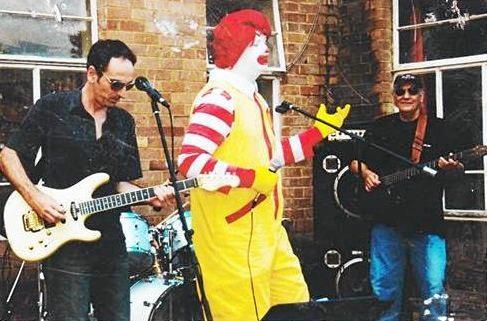 Ray Norman playing guitar in a band with Ronald McDonald. Picture: -