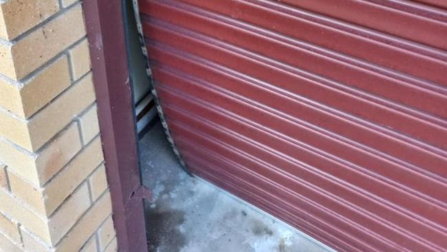 The elderly Hillcrest couple's roller door was crashed into and bent and broken.