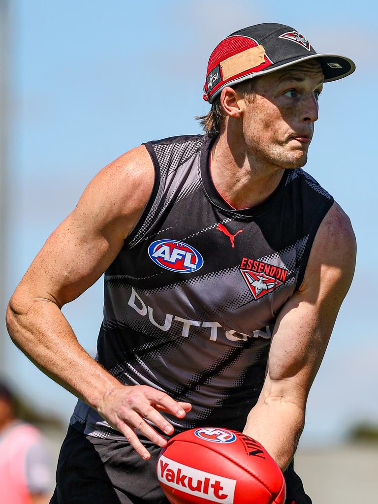 Mason Redman dishes a handball at Essendon training. Picture: Essendon FC