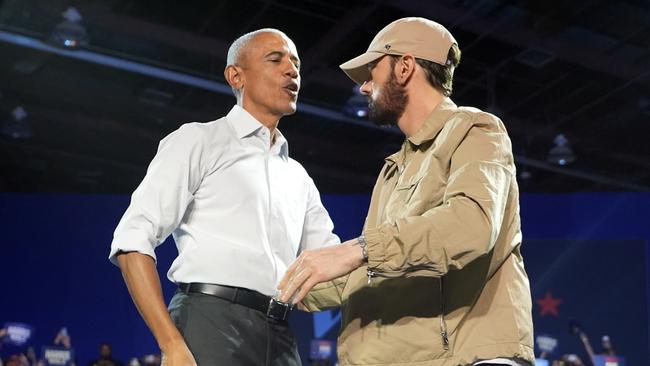 Rapper Eminem greets former President Barack Obama on stage at a campaign rally supporting Democratic presidential nominee Vice President Kamala Harris. Picture:Paul Sancya