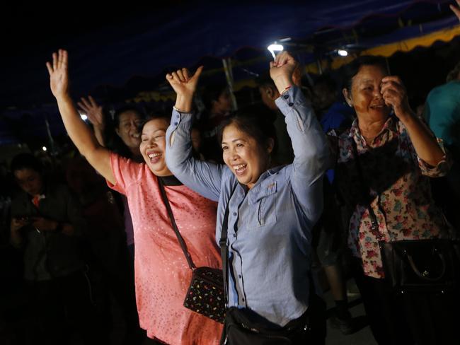 People celebrate after evacuation in Chiang Rai as divers evacuated some of the 12 boys and their coach trapped at Tham Luang cave. Picture: AP