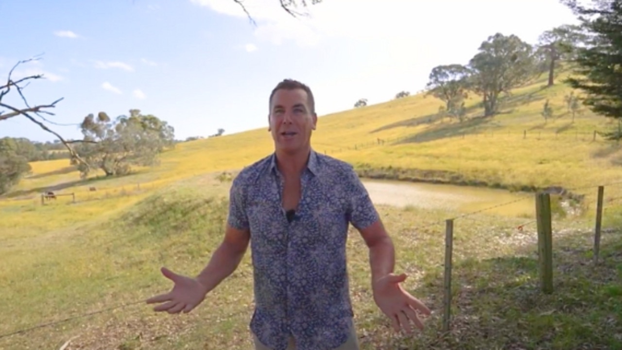 Wayne Carey admires at the property’s views, in the listing video.