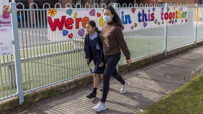 A student at St Patrick’s Primary in Murrumbeena leaves school after another student tested positive to Covid-19. Picture: Wayne Taylor