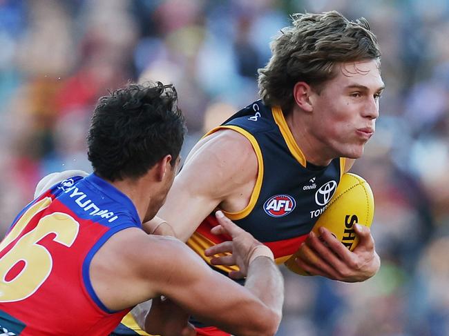 ADELAIDE, AUSTRALIA - MAY 12: Cam Rayner of the Lions tackles Daniel Curtin of the Crows during the 2024 AFL Round 09 match between the Adelaide Crows and the Brisbane Lions at Adelaide Oval on May 12, 2024 in Adelaide, Australia. (Photo by James Elsby/AFL Photos via Getty Images)