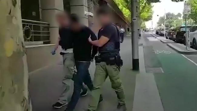 Arrested people in relation to the Malaysian drug syndicate are taken into AFP HQ in Melbourne