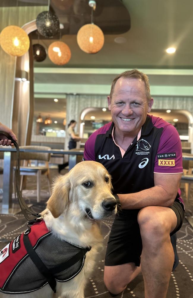 Brisbane Broncos coach Kevin Walters with the Smartpup (Kevvie).