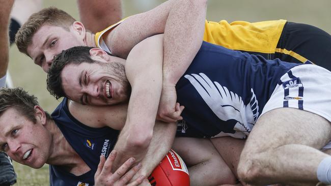 Liam Hulett from Edithvale-Aspendale finds himself sandwiched on the ground. Picture: Valeriu Campan