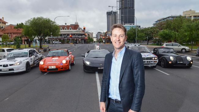 Organiser Tim Possingham in Rundle Rd with some of the cars that will compete in the Adelaide Rally in December. Picture: AAP Photo / Brenton Edwards