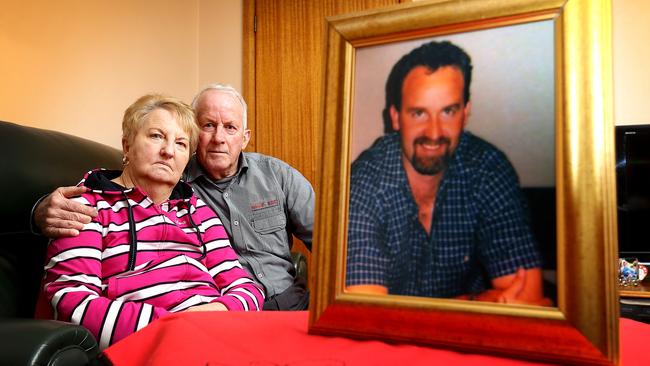 Barbara and Rob Barker with a photo of their son Shane at home in Campbell Town.