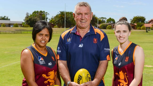 Eight-time Port Adelaide SANFL premiership player Greg Phillips will coach SMOSH West Lakes’ inaugural women’s team in the Adelaide Footy League’s division one. Phillips, pictured with SMOSH players Bronwyn Davey (left) and Remy Grant (right). Picture: AAP/Brenton Edwards