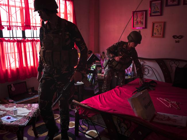 Philippine security forces inspect houses within the vicinity of a military camp and a hospital for guns and ammunition in Marawi city. Picture: Jes Aznar/Getty Images