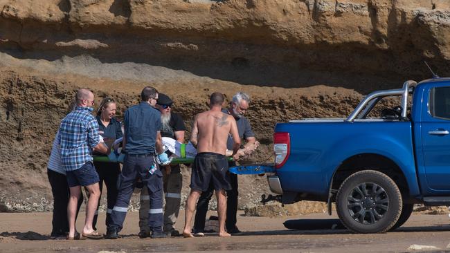 Man rescued after hitting head on reef at Bird Rock, Jan Juc. Locals and paramedics worked together to treat and move the man, using a resident's ute. Pictures: Shaun Viljoen