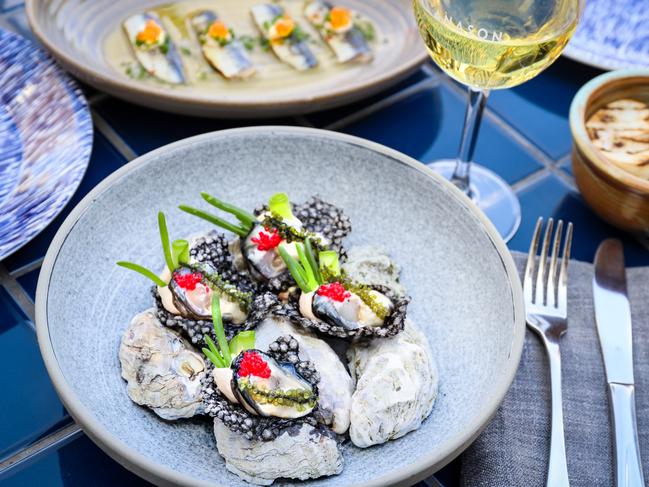 Oysters on squid-ink crackers served at Anason. Picture: Jenifer Jagielski