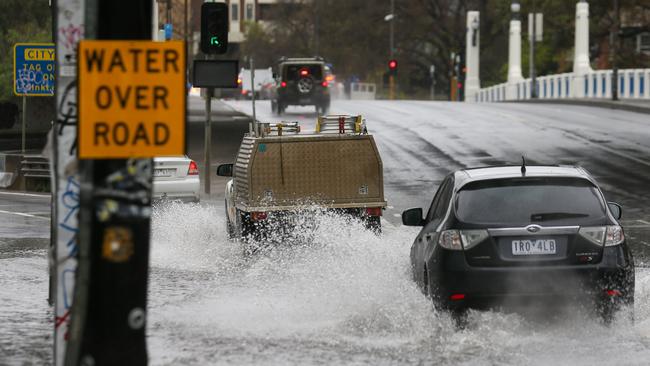 A flooded road is closed at the intersection of Punt Rd and Gough St in Richmond. Picture: Brendan Beckett