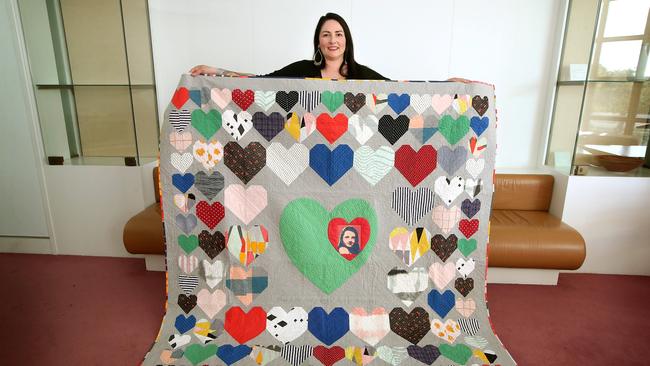 Sonia Ryan holding Carly’s memorial quilt.